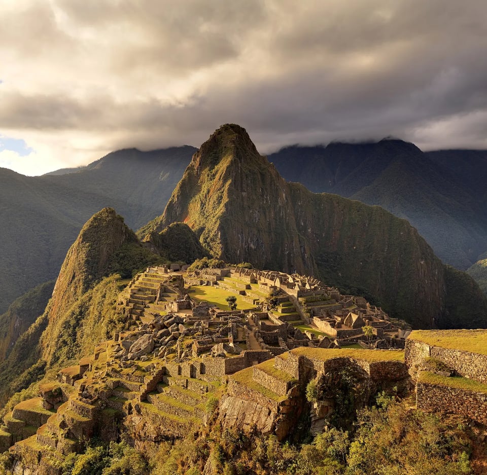 The stone ruins of Machu Picchu beneath the peak of Huayna Picchu in the Peruvian Andes