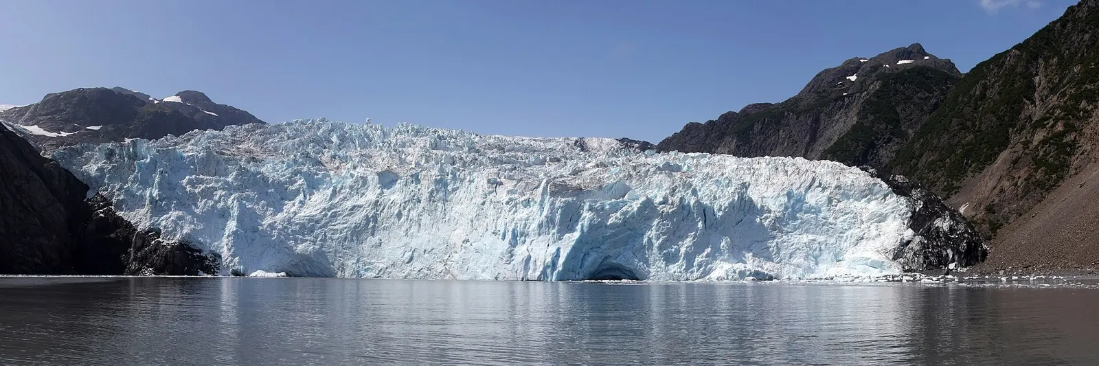 A tidewater glacier meeting a calm fjord in Alaska