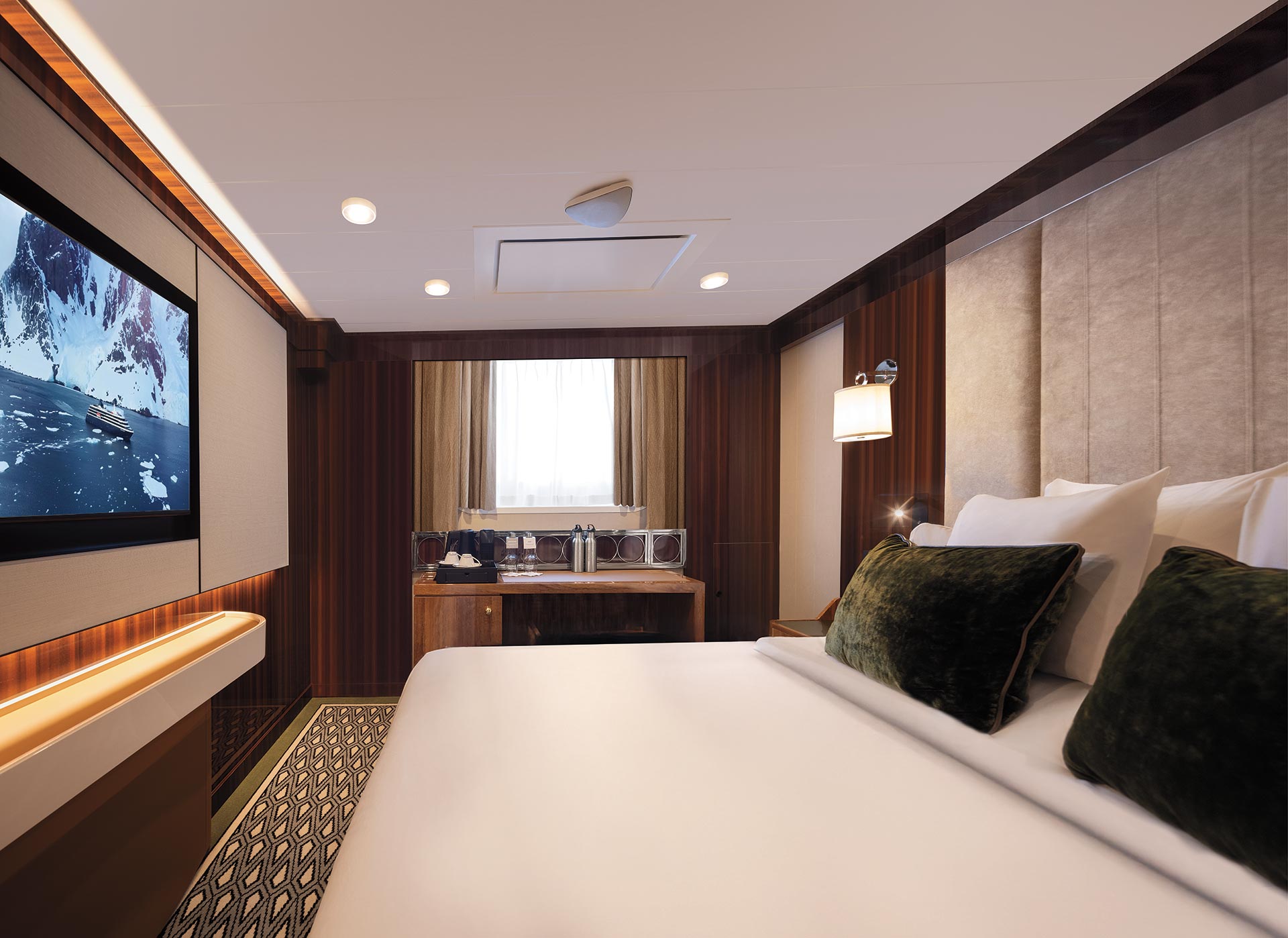 An Adventure Oceanview stateroom with a queen bed and a large picture window