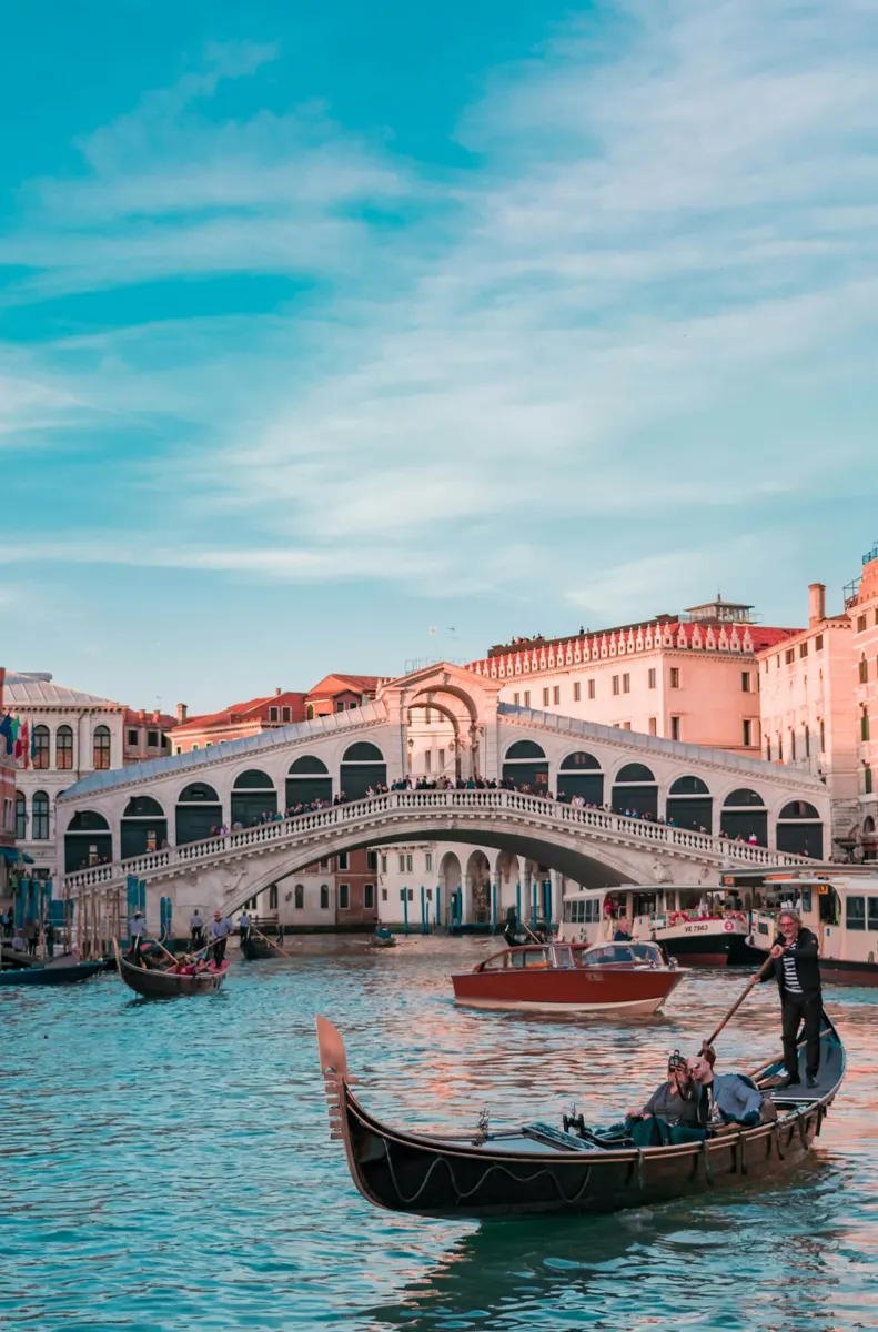 A gondola passing beneath the Rialto Bridge on the Grand Canal in Venice