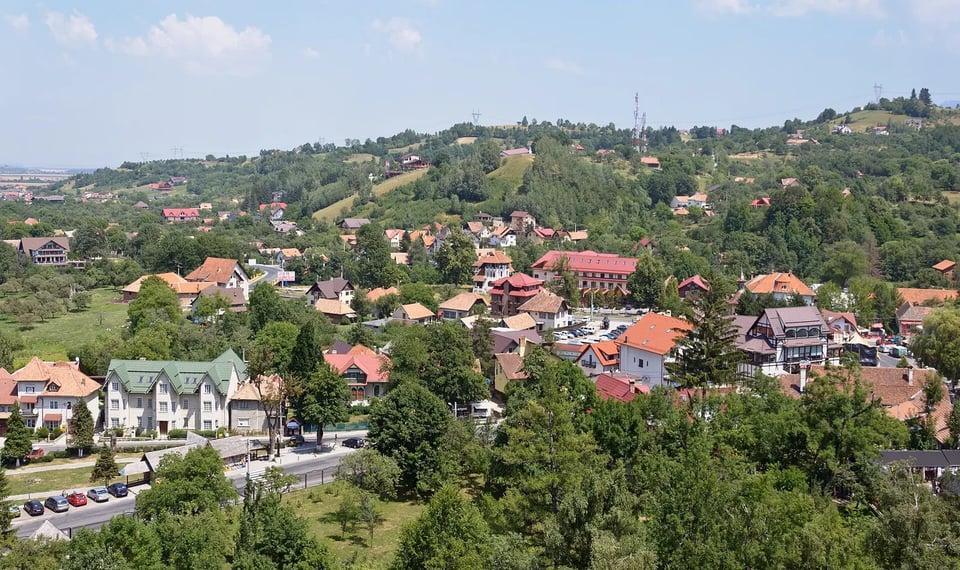The village of Bran and green Transylvanian hills seen from Bran Castle in Romania