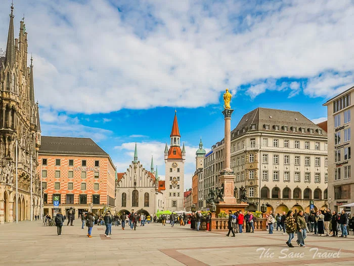 Munich's Marienplatz with the New Town Hall and the golden Mariensäule column under a blue sky