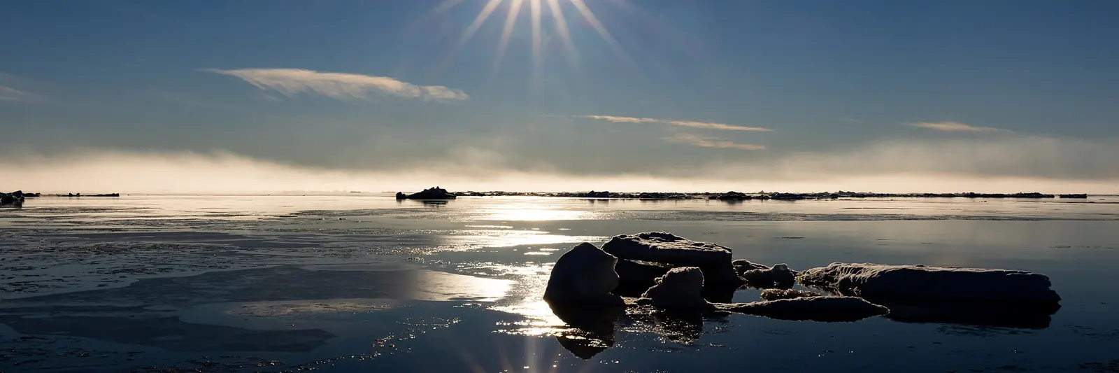 The midnight sun low over Arctic sea ice