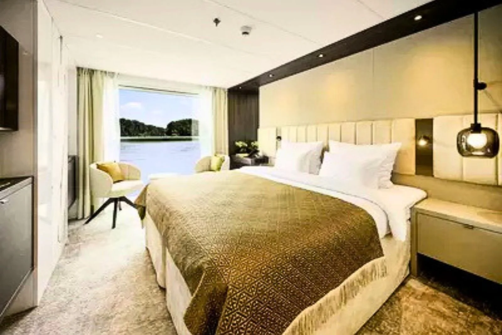 A river cruise cabin with the French balcony window open to the river