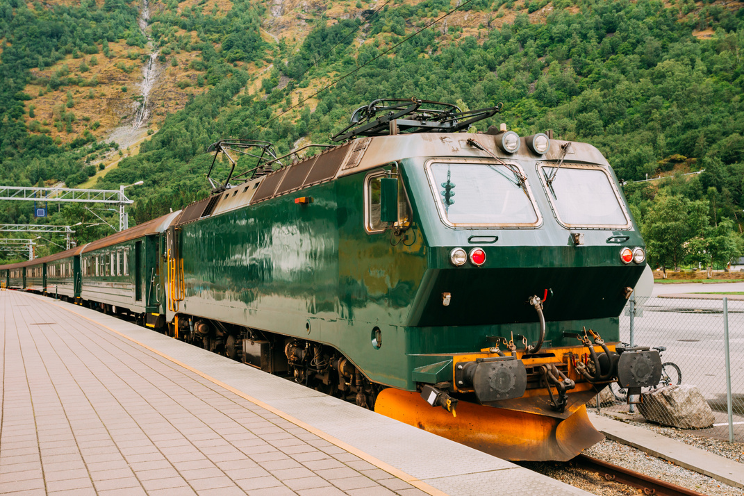 Flam, Norway. Famous Railroad Flamsbahn. Green Norwegian Train Near Railway Station